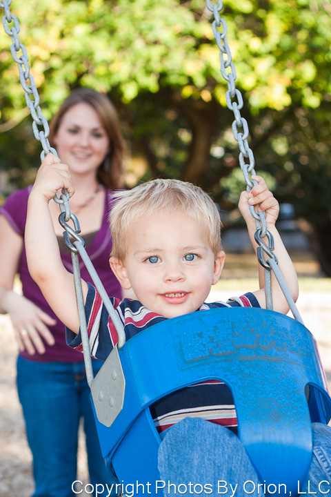 Portrait of a little boy swinging at Bush Park
