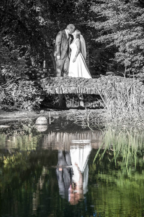 Wedding couple kiss on bridge at private residence in Salem, Oregon