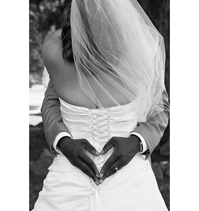 Wedding couple with heart behind back